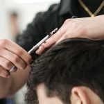 young man getting a haircut at mgx barbers Hayward CA